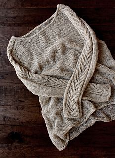 an old sweater laying on top of a wooden table