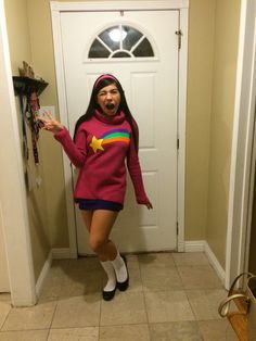 a woman standing in front of a door wearing a pink sweater and white socks with a rainbow star on it