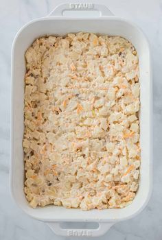 an uncooked casserole dish with carrots and other ingredients in it