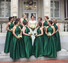 a bride and her bridal party in front of the stately entrance to the capitol building