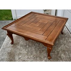 a wooden coffee table sitting on top of a carpeted floor next to a white door