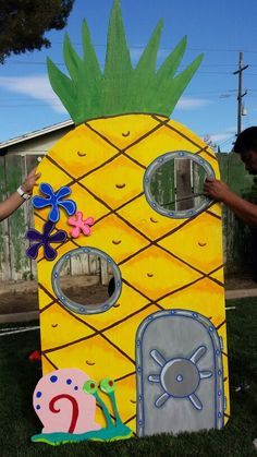 a child's cardboard house made to look like a pineapple