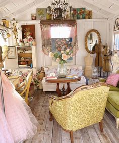 a living room filled with furniture and lots of clutter on top of wooden floors