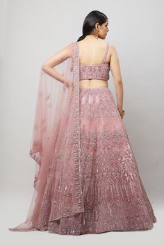 A beautiful pink lehenga with tonal and silver stonework! Fabric: Net with satin lining All preorders will be handled by a Nazranaa Bridal Consultant who will virtually discuss measurements and minor changes according to the client's specifications Occasion: Wedding Reception WASH CARE INSTRUCTIONS - Please Dry clean only when it is applicable. Slight color variation is possible due to digital photography. Jewelry not included Pink Party Wear Choli With Cutdana, Elegant Pink Cutdana Lehenga, Photography Jewelry, Bridal Consultant, Pink Lehenga, Digital Photography, Lehenga, Wedding Reception, Color Variations