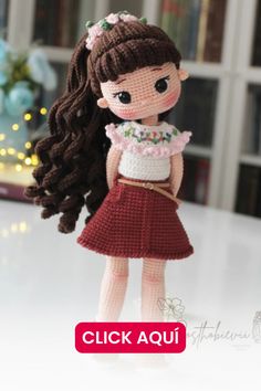 the doll is wearing a dress and holding a purse