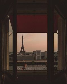 the eiffel tower is seen through an open window in this view from inside a building