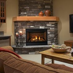 a living room filled with furniture and a fire place next to a flat screen tv