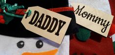 a close up of a snowman with a name tag on it