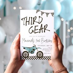 a person holding up a card with a motorcycle on it and the words third gear