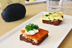 two pieces of food on a white plate