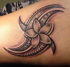 a woman's thigh with a flower tattoo on it