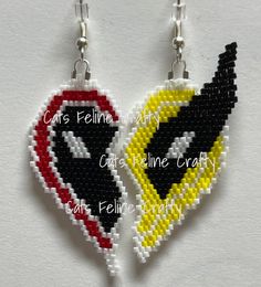 two cross stitch earrings with the words cats feline kitty and cat fluine crazy on them