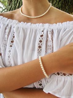 "This classic and timeless real pearl bracelet is created with gorgeous 6.5mm round freshwater pearls and a sterling silver oval lobster clasp with a 1/2\" sterling silver extender chain. All metal components are sterling silver. Arrives packaged in my signature high-quality reusable canvas gift bag. Beautiful and ready for gift giving. S I Z I N G . G U I D E The bracelet should be about 1\" larger than wrist size. If you are unable to measure, you may use this guide for approximate bracelet si Classic Single Strand Pearl Bracelet For Gift, Classic Pearl White Beaded Pearl Bracelets, Classic Pearl White Beaded Pearl Bracelet, Classic Pearl White Hypoallergenic Pearl Bracelet, Classic Hypoallergenic Pearl White Pearl Bracelet, Bridesmaid Pearl Bracelet, Real Pearl Bracelet, Canvas Gift Bag, Real Pearl Necklace