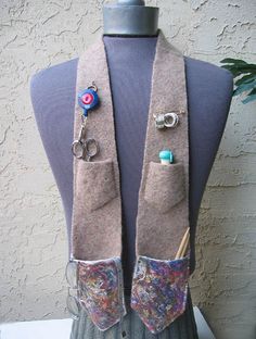 a mannequin with some buttons and scissors on it's lapel collar