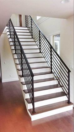 an empty room with stairs leading up to the second floor