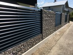 a black metal fence on the side of a building