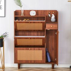 a wooden cabinet with wicker baskets on the top and bottom shelf, against a wall