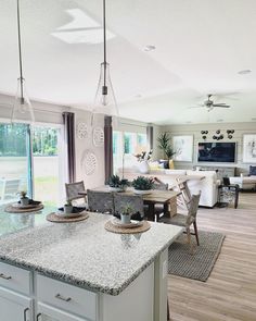 a large kitchen with an island in the middle and lots of counter space around it