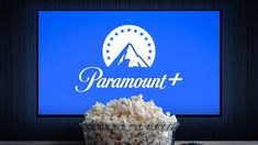 a bowl full of popcorn sitting in front of a tv with the word paramount on it