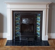 an ornate fireplace with blue and green tiles