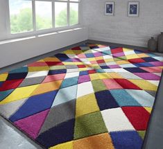 a multicolored area rug in the corner of a room