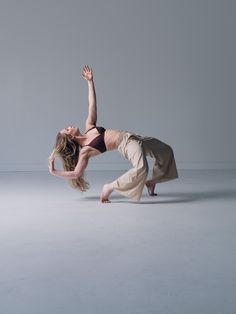 a woman is doing a handstand on the floor