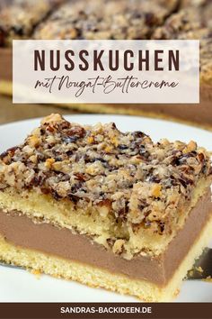 a close up of a piece of cake on a plate with the words nusskuchen next to it