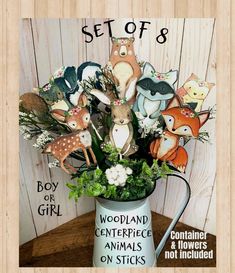 an arrangement of stuffed animals in a watering can with the words, set of 8 woodland centerpiece animals on sticks