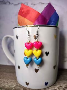 Show your pansexual pride with these beaded earrings, featuring heart-shaped pony beads representing the colors of the pansexual pride flag! Can't find your flag? Prefer a different style? Shoot us a message to inquire about a custom order! All of our earrings are nickel and lead free and sanitized before shipping to you. Pansexual Earrings, Multicolor Heart Beads Dangle Earrings, Adjustable Multicolor Heart Earrings For Valentine's Day, Pansexual Pride, Pony Beads, Heart Earrings, Different Styles, Beaded Earrings, Jewelry Earrings Dangle