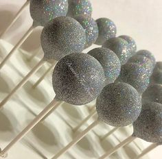 silver glitter cake pops sitting on top of each other