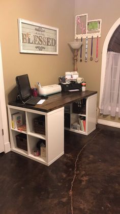 a computer desk sitting in the corner of a room