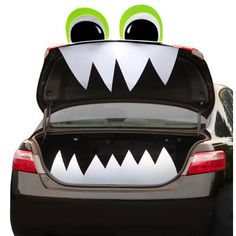 a car with monster eyes and teeth on it's trunk