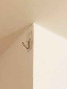 the corner of a wall with a hook on it