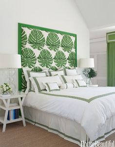 a bedroom with green and white decor on the walls