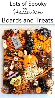 an assortment of halloween treats on a wooden board with the words spooky snack board