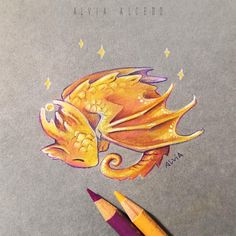 a drawing of a yellow dragon with its eyes closed and two pencils next to it