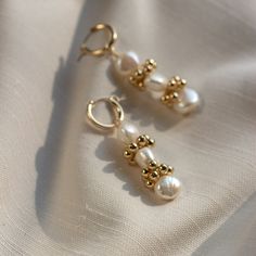 "The Baroque Eyelet Mini Hoop Earrings feature a mini hoop that hugs the earlobe and a genuine baroque pearl dangle with gold or silver signature clustering. They are perfect for everyday wear! Lightweight and comfortable to wear. Wear them two ways - slide the dangle off to wear just the simple hoop earring. \"BAROQUE EYELET MINI HOOP EARRINGS\" by GoldenLinings - Christine Elizabeth Jewelry D E T A I L S Materials: 14K Gold Fill or Sterling Silver Closure: latch hook S I Z E S Measures appox. Elegant Gold Plated Huggie Pearl Earrings, Elegant 14k Gold Filled Huggie Cartilage Earrings, Delicate Yellow Gold Hoop Pearl Earrings, Gold Plated Yellow Gold Huggie Earrings With Pearl Drop, Single 14k Gold Filled Drop Pearl Earring, Single 14k Gold-filled Round Pearl Earring, Elegant Pearl Huggie Earrings For Gifts, Gold Huggie Pearl Earrings As Gift, Gold Huggie Pearl Earrings For Gift