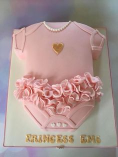 a cake that is shaped to look like a baby's bodysuit and diaper