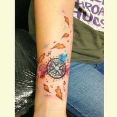 a person with a tattoo on their arm and the wrist is covered in watercolor