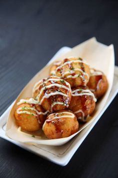 a white plate topped with food covered in cheese and sauce on top of a wooden table