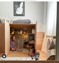 two children are sitting on the floor in their bunk beds