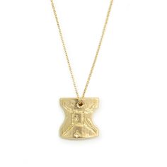 a gold necklace with a cross on it