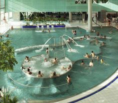 an indoor swimming pool with people in it