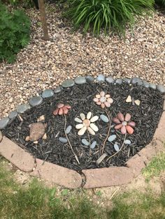 a flower bed made out of rocks and gravel