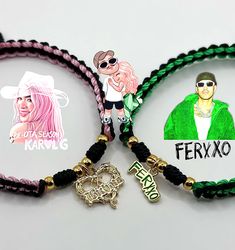 three bracelets with charms on them sitting next to each other