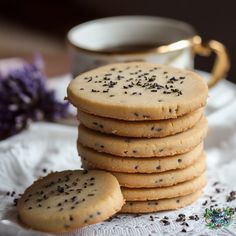 a stack of cookies sitting next to a cup of coffee