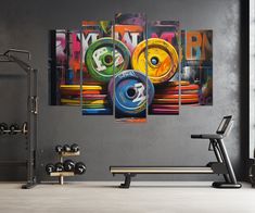 a gym room with colorful wall art and exercise equipment