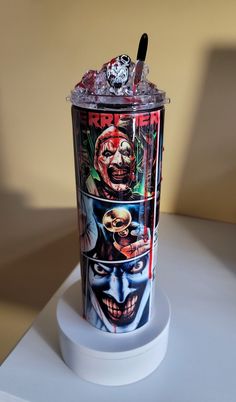 a cup with an image of the jokers on it is sitting on a table