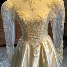 a white wedding dress on display in a room