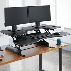 a computer desk with two monitors and a keyboard